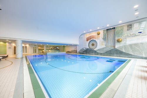 Der große Innenpool bildet zusammen mit dem Kinderbecken, den Whirlpools und den Saunas den Wellnessbereich im Hotel AllgäuStern.